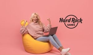 Happy woman celebrating on computer next to logo for Hard Rock Games, a social casino company that shows Hard Rock's future Florida online casino plans