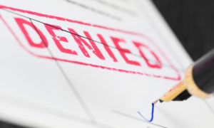 A denial document getting signed