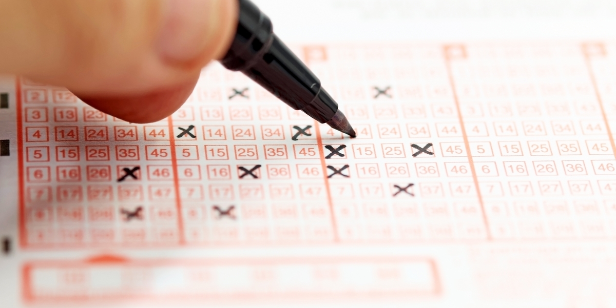 A man filling out a lottery ticket