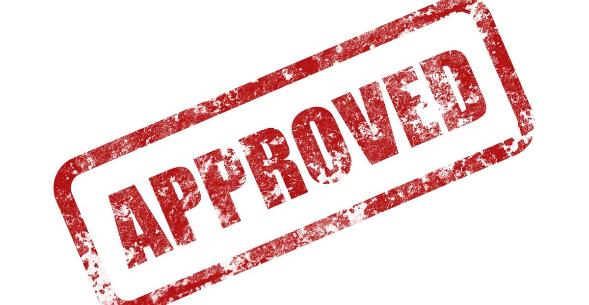 a red approved stamp over a white background
