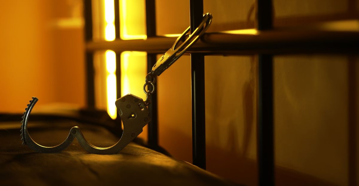 a jail cell with a pair of handcuffs attached to the bars